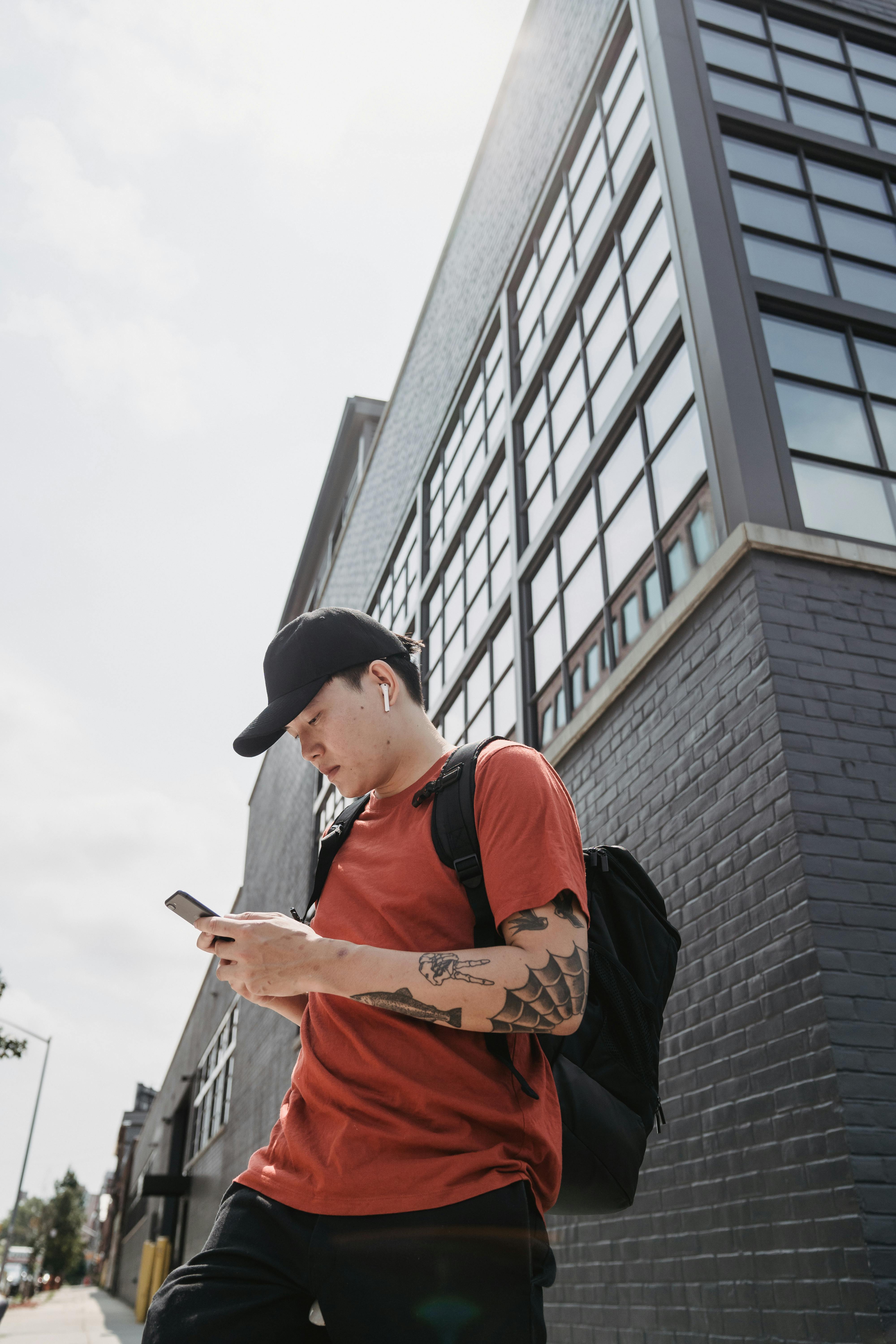 Person using mobile phone with HYPƐAR custom in-ear monitors for everyday music listening and phone calls - 3D-printed custom-fit earbuds that stay secure during daily activities, providing superior sound quality and noise isolation
